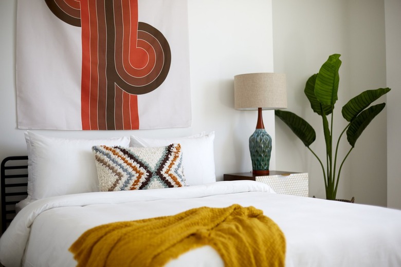 Bohemian bedroom with fabric wall hanging